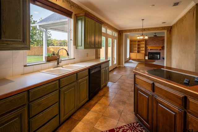 kitchen with plenty of natural light, black appliances, a chandelier, and sink