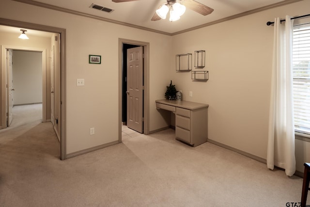 interior space featuring ceiling fan, light colored carpet, and ornamental molding