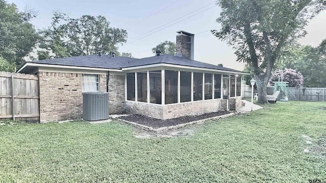 3004 Tower Dr, Tyler, TX 75701 - rear view of house with a sunroom, a chimney, and brick siding