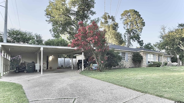 3004 Tower Dr, Tyler, TX 75701 - view of side of home with concrete driveway and a carport