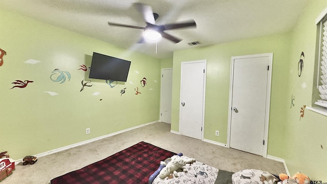 3004 Tower Dr, Tyler, TX 75701 - bedroom featuring carpet flooring, a textured ceiling, and ceiling fan