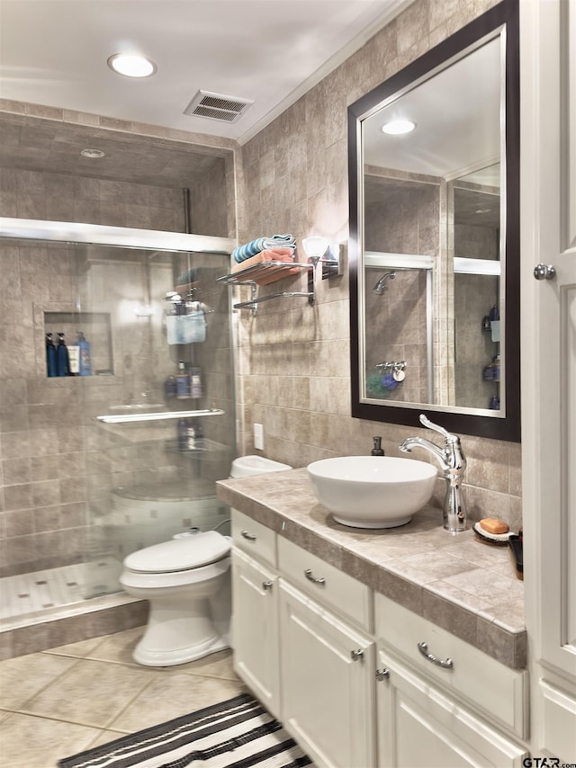 3004 Tower Dr, Tyler, TX 75701 - full bath featuring tile walls, vanity, a stall shower, decorative backsplash, and tile patterned floors
