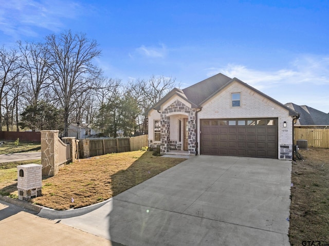 french country style house with cooling unit, a garage, brick siding, fence, and concrete driveway