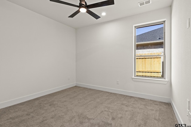 unfurnished room featuring a ceiling fan, carpet, visible vents, and baseboards