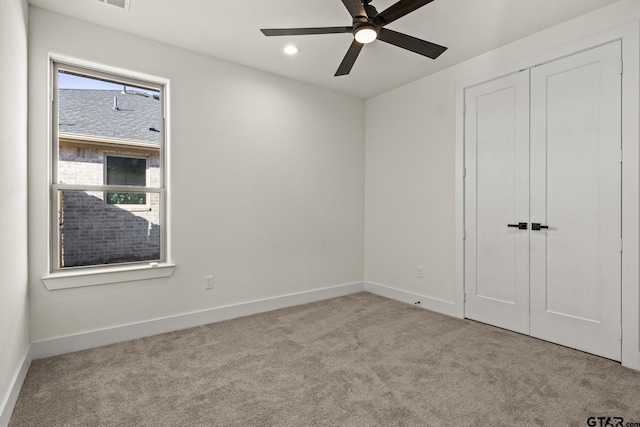 unfurnished bedroom featuring ceiling fan, recessed lighting, baseboards, a closet, and carpet