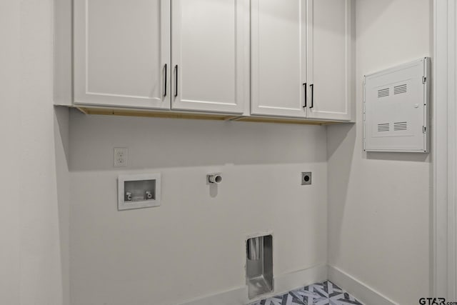 washroom featuring cabinet space, hookup for a washing machine, electric dryer hookup, and baseboards