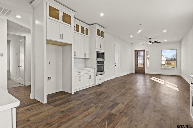 kitchen with light countertops, visible vents, decorative backsplash, appliances with stainless steel finishes, and white cabinetry