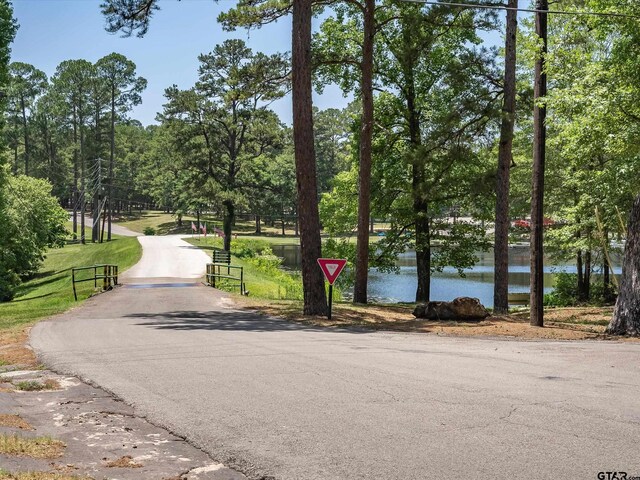 121 Rolling Rdg, Holly Lake Ranch, TX 75765 - view of street featuring a water view, view of wooded area, and a gated entry