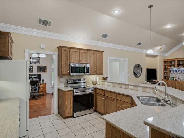 121 Rolling Rdg, Holly Lake Ranch, TX 75765 - kitchen with stainless steel appliances, a sink, crown molding, light tile patterned flooring, and decorative backsplash