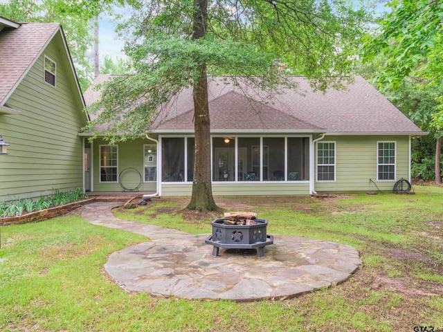121 Rolling Rdg, Holly Lake Ranch, TX 75765 - rear view of property featuring a fire pit, a sunroom, a yard, and a patio