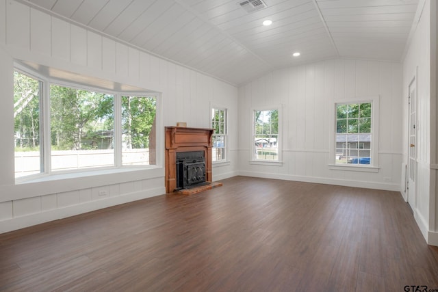 unfurnished living room featuring a wealth of natural light, visible vents, vaulted ceiling, and dark wood-type flooring