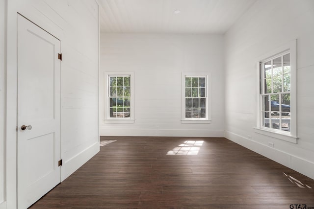 spare room with dark wood finished floors