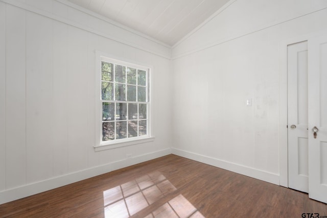 unfurnished room with lofted ceiling, wood finished floors, and baseboards