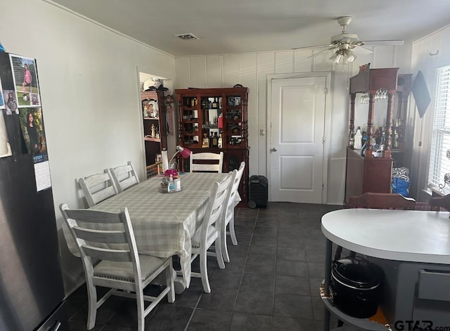 tiled dining space with a wealth of natural light and ceiling fan