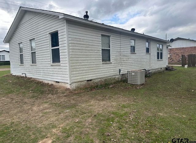 view of home's exterior with a lawn and central air condition unit