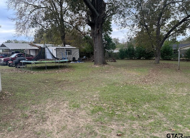 view of yard with a trampoline