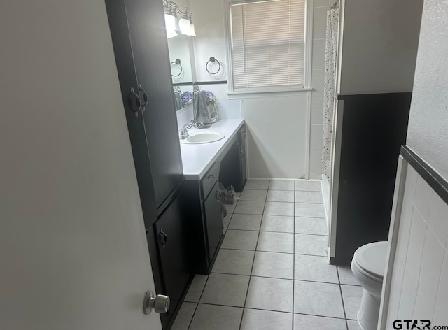 bathroom featuring tile patterned floors, vanity, and toilet