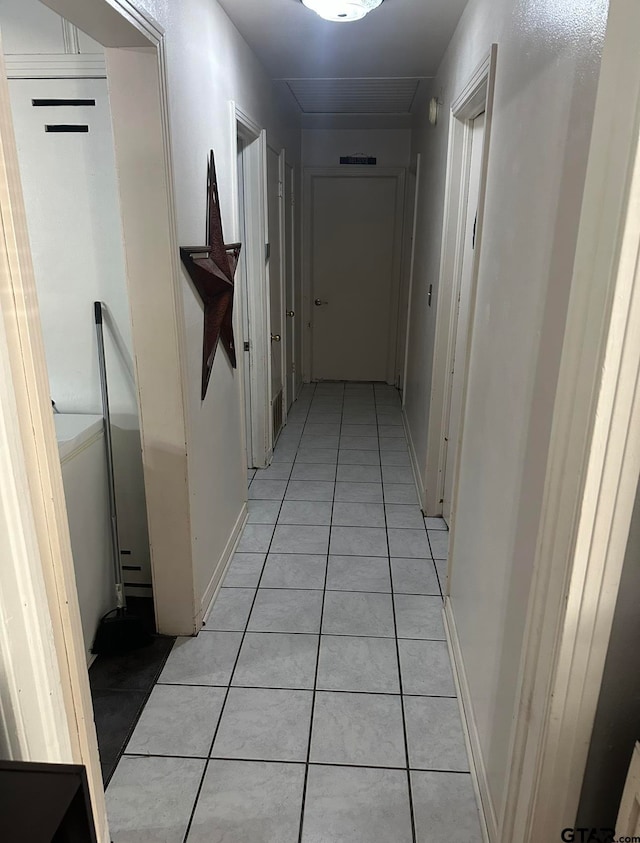 corridor with light tile patterned flooring