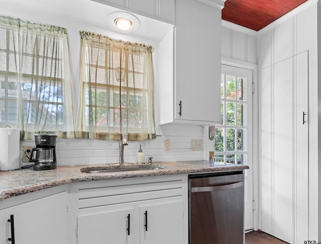 kitchen featuring ornamental molding, light stone countertops, sink, white cabinets, and dishwasher