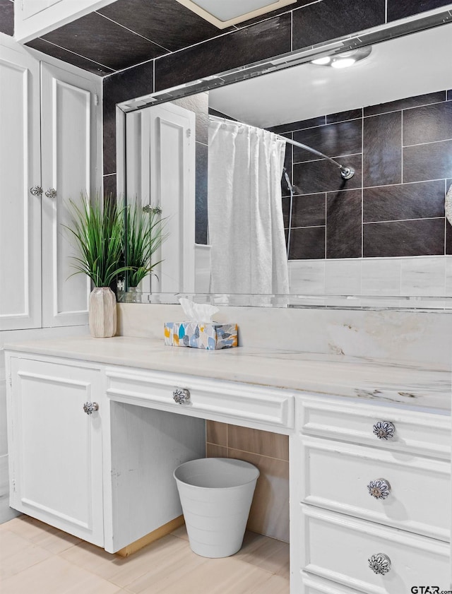 bathroom featuring vanity and a shower with shower curtain