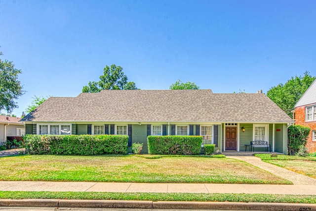 ranch-style home featuring a front yard and covered porch