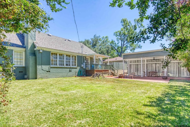 rear view of property featuring a patio and a yard