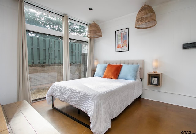 bedroom featuring concrete flooring