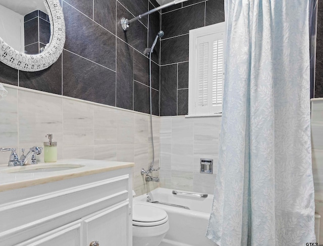 full bathroom featuring toilet, vanity, shower / tub combo with curtain, and tile walls