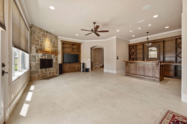 5581 Nancy Cir, Chandler, TX 75758 - unfurnished living room featuring arched walkways, recessed lighting, crown molding, a ceiling fan, and a fireplace