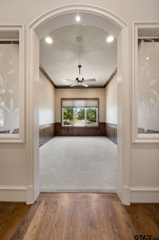 5581 Nancy Cir, Chandler, TX 75758 - unfurnished room featuring ornamental molding, a wainscoted wall, a ceiling fan, and wood finished floors