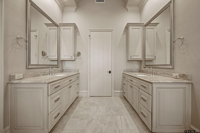 5581 Nancy Cir, Chandler, TX 75758 - bathroom with two vanities, ornamental molding, baseboards, and marble look tile flooring