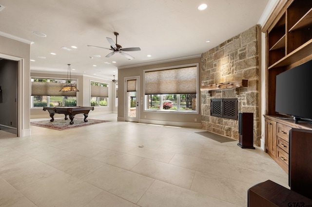 5581 Nancy Cir, Chandler, TX 75758 - living room with crown molding, billiards, healthy amount of natural light, a stone fireplace, and ceiling fan