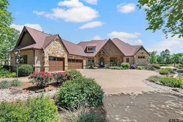 5581 Nancy Cir, Chandler, TX 75758 - view of front of home featuring stone siding, an attached garage, and driveway