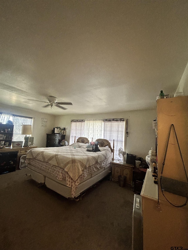 carpeted bedroom featuring multiple windows and ceiling fan