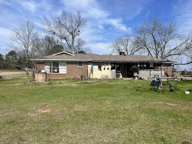 back of property featuring a lawn