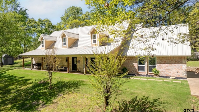 rear view of property with a lawn