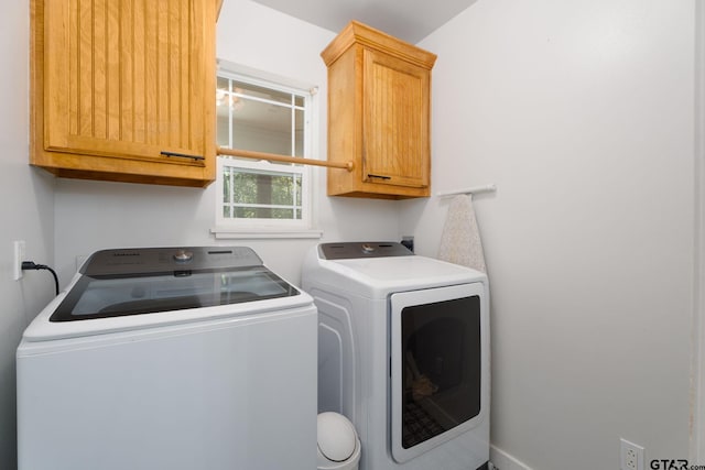 laundry room featuring cabinets and separate washer and dryer