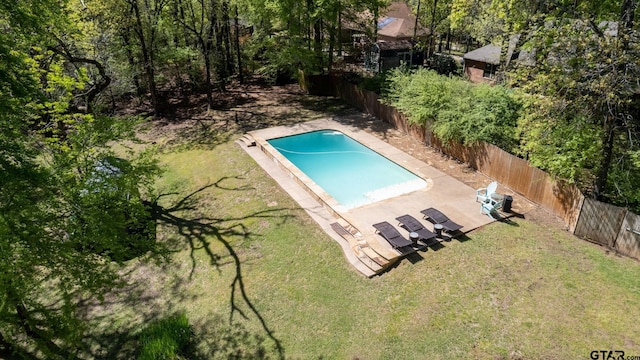 view of pool with a patio area and a lawn