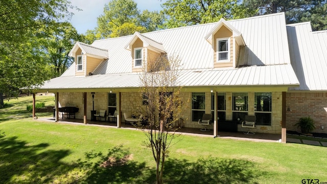 back of property with a patio and a yard