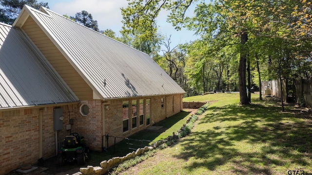 view of home's exterior with a lawn