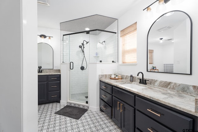 bathroom featuring vanity and a shower with door