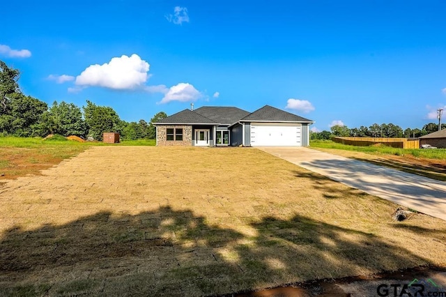 view of front of home featuring a garage and a front lawn