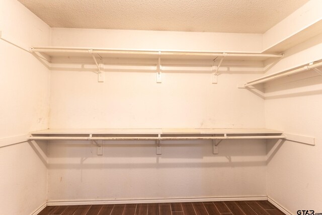 1853 Woodbridge Dr, Sulphur Springs, TX 75482 - spacious closet featuring dark wood-style floors