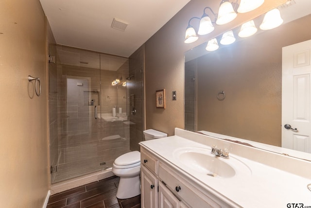 1853 Woodbridge Dr, Sulphur Springs, TX 75482 - full bathroom with toilet, wood finish floors, a stall shower, vanity, and a textured wall