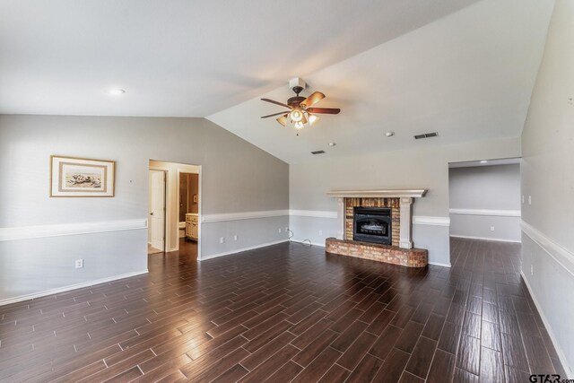 1853 Woodbridge Dr, Sulphur Springs, TX 75482 - unfurnished living room with a ceiling fan, lofted ceiling, dark wood finished floors, baseboards, and a brick fireplace