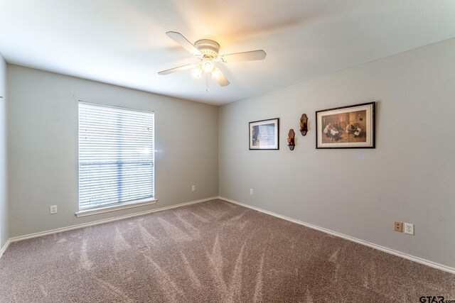 1853 Woodbridge Dr, Sulphur Springs, TX 75482 - carpeted empty room with a ceiling fan and baseboards