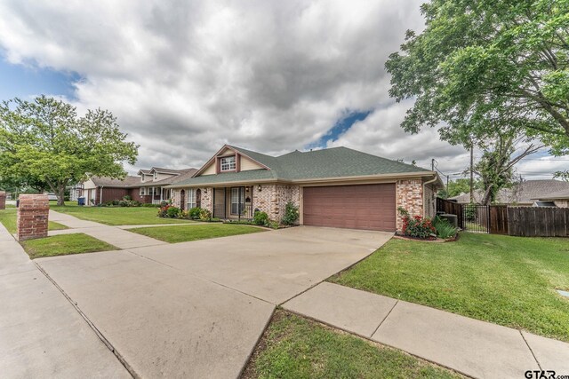 1853 Woodbridge Dr, Sulphur Springs, TX 75482 - traditional-style house with an attached garage, concrete driveway, brick siding, and a shingled roof