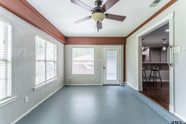 1853 Woodbridge Dr, Sulphur Springs, TX 75482 - unfurnished room featuring finished concrete flooring, baseboards, plenty of natural light, and ceiling fan