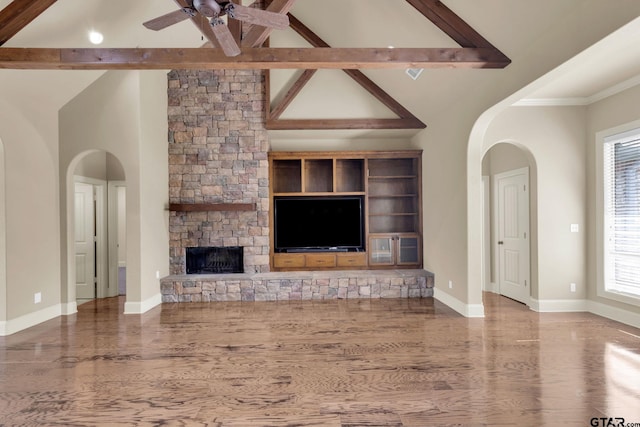 unfurnished living room with a fireplace, hardwood / wood-style flooring, beamed ceiling, and high vaulted ceiling