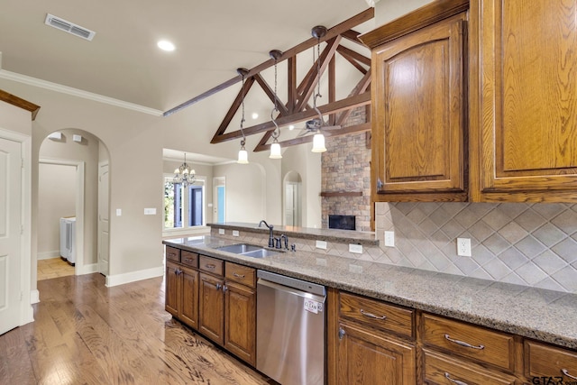 kitchen featuring light hardwood / wood-style floors, sink, ornamental molding, stainless steel dishwasher, and light stone countertops